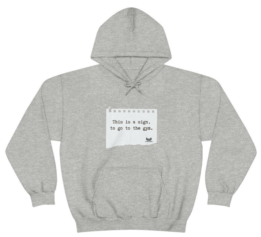 Picture of the Fitness Geeker graphic saying "This is a sign, to go to the Gym" Heavy Blend Hooded Sweatshirt (front) in grey